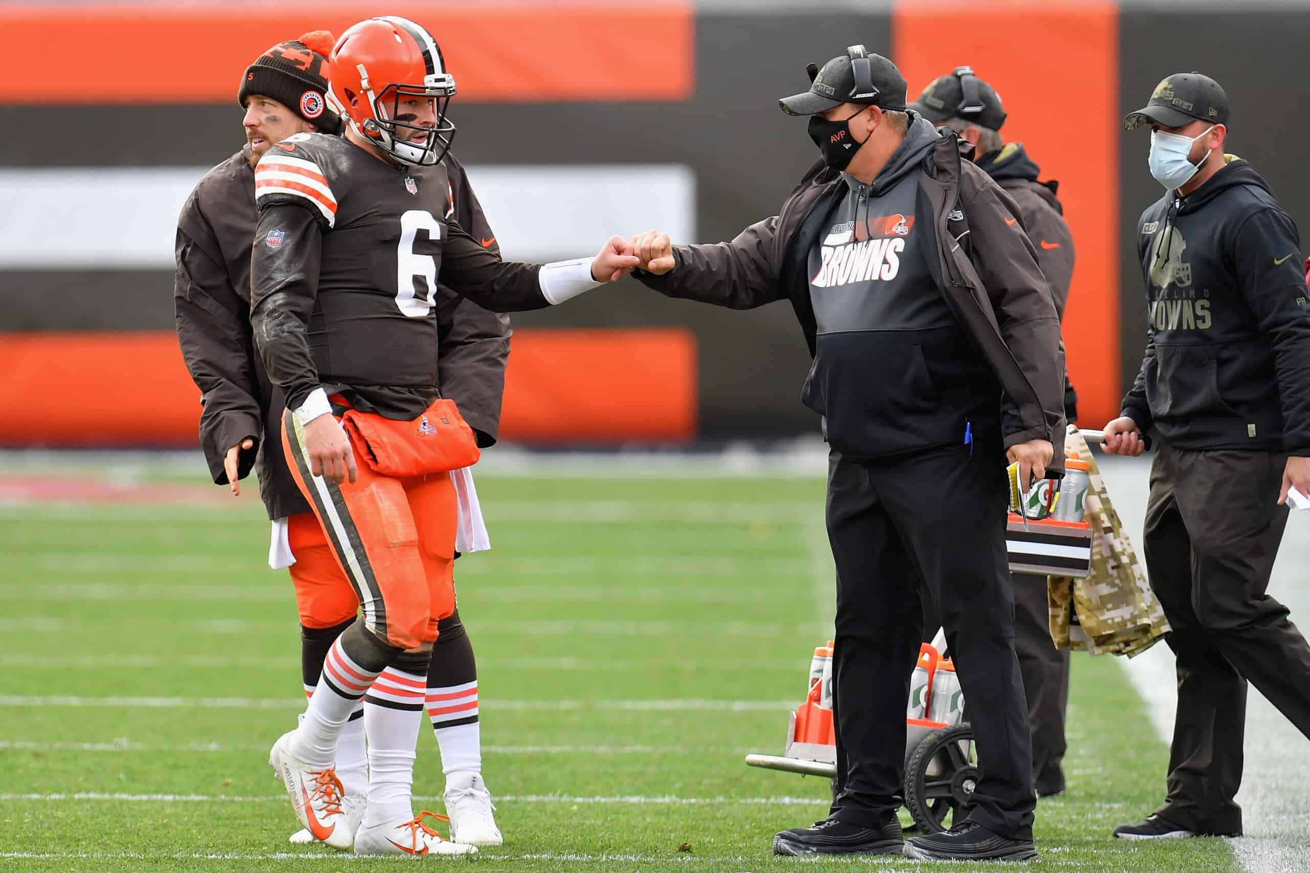 Quarterback Baker Mayfield #6 of the Cleveland Browns is greeted by offensive coordinator Alex Van Pelt as he walks off the field during the first half of the NFL game against the Las Vegas Raiders at FirstEnergy Stadium on November 01, 2020 in Cleveland, Ohio.