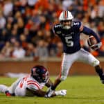 Anthony Schwartz #5 of the Auburn Tigers breaks a tackle by Benito Jones #95 of the Mississippi Rebels in the first half at Jordan-Hare Stadium on November 02, 2019 in Auburn, Alabama.