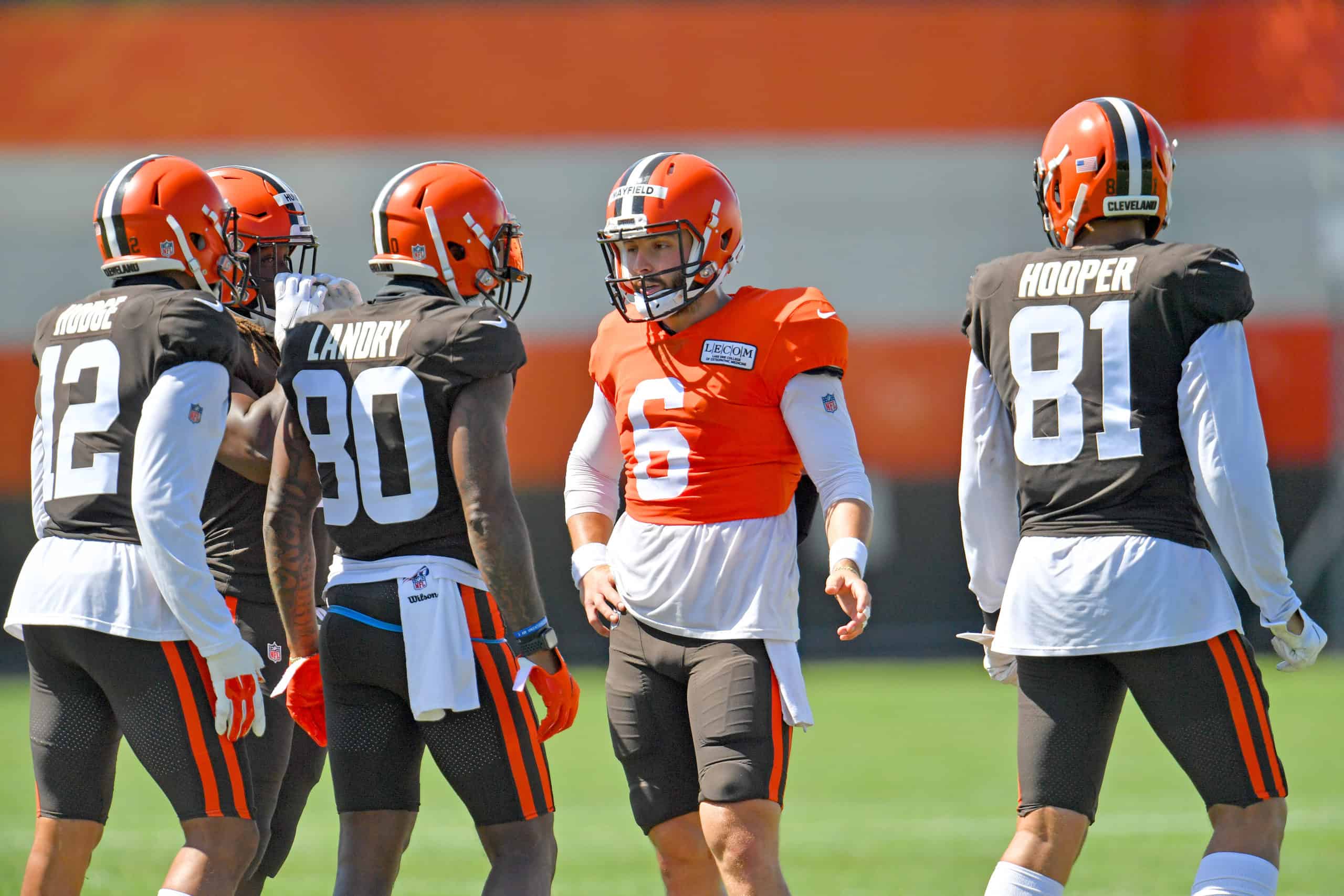 Quarterback Baker Mayfield #6 of the Cleveland Browns talks to wide receiver KhaDarel Hodge #12 wide receiver Jarvis Landry #80 tight end Austin Hooper #81 during an NFL training camp at the Browns training facility on August 18, 2020 in Berea, Ohio. 