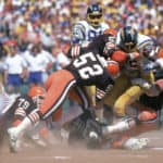 Linebackers Dick Ambrose #52 and Tom Cousineau #50, Chip Banks #54 of the Cleveland Browns tackle running back Chuck Muncie #46 of the San Diego Chargers during a game at Jack Murphy Stadium on September 25, 1983 in San Diego, California. The Browns won 30-24 in overtime.