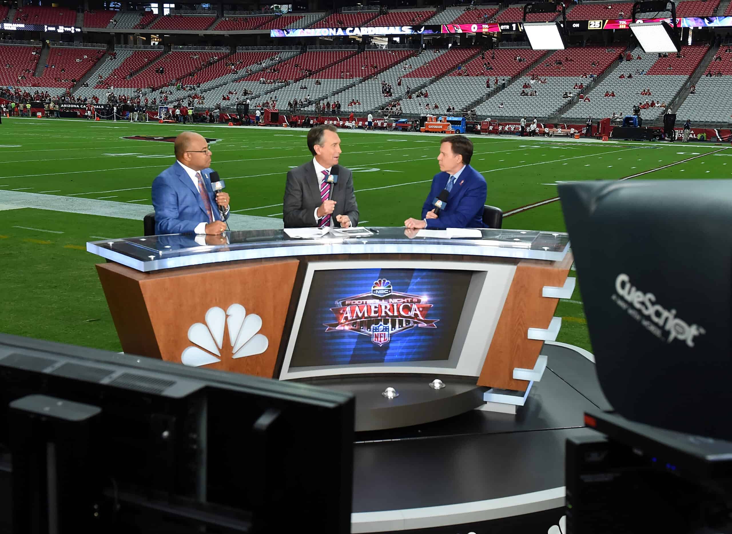 Sunday Night Football Commentators Mike Tirico, Cris Collinsworth and Bob Costas report prior to the NFL game between the New England Patriots and Arizona Cardinals at University of Phoenix Stadium on September 11, 2016 in Glendale, Arizona. 