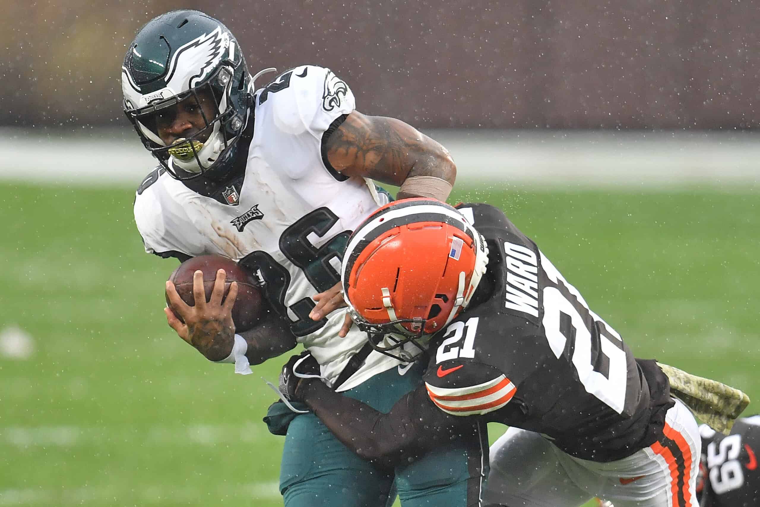 Miles Sanders #26 of the Philadelphia Eagles is brought down by Denzel Ward #21 of the Cleveland Browns during the first half at FirstEnergy Stadium on November 22, 2020 in Cleveland, Ohio.