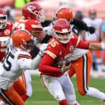 Quarterback Patrick Mahomes #15 of the Kansas City Chiefs scrambles as defensive end Myles Garrett #95 of the Cleveland Browns chases during the AFC Divisional Playoff game at Arrowhead Stadium on January 17, 2021 in Kansas City, Missouri.