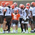 Quarterback Baker Mayfield #6 and running back Kareem Hunt #27 of the Cleveland Browns in the huddle during Cleveland Browns Training Camp on July 30, 2021 in Berea, Ohio.