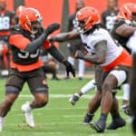 Offensive tackle James Hudson III #66 of the Cleveland Browns blocks defensive end Myles Garrett #95 during the second day of Cleveland Browns Training Camp on July 29, 2021 in Berea, Ohio.