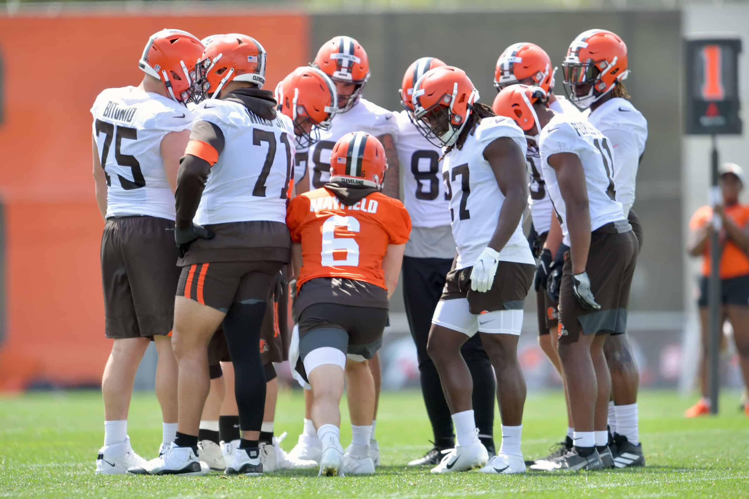 Quarterback Baker Mayfield #6 and running back Kareem Hunt #27 of the Cleveland Browns in the huddle during Cleveland Browns Training Camp on July 30, 2021 in Berea, Ohio.