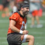 Quarterback Baker Mayfield #6 of the Cleveland Browns jokes with teammates during the first day of Cleveland Browns Training Camp on July 28, 2021 in Berea, Ohio.