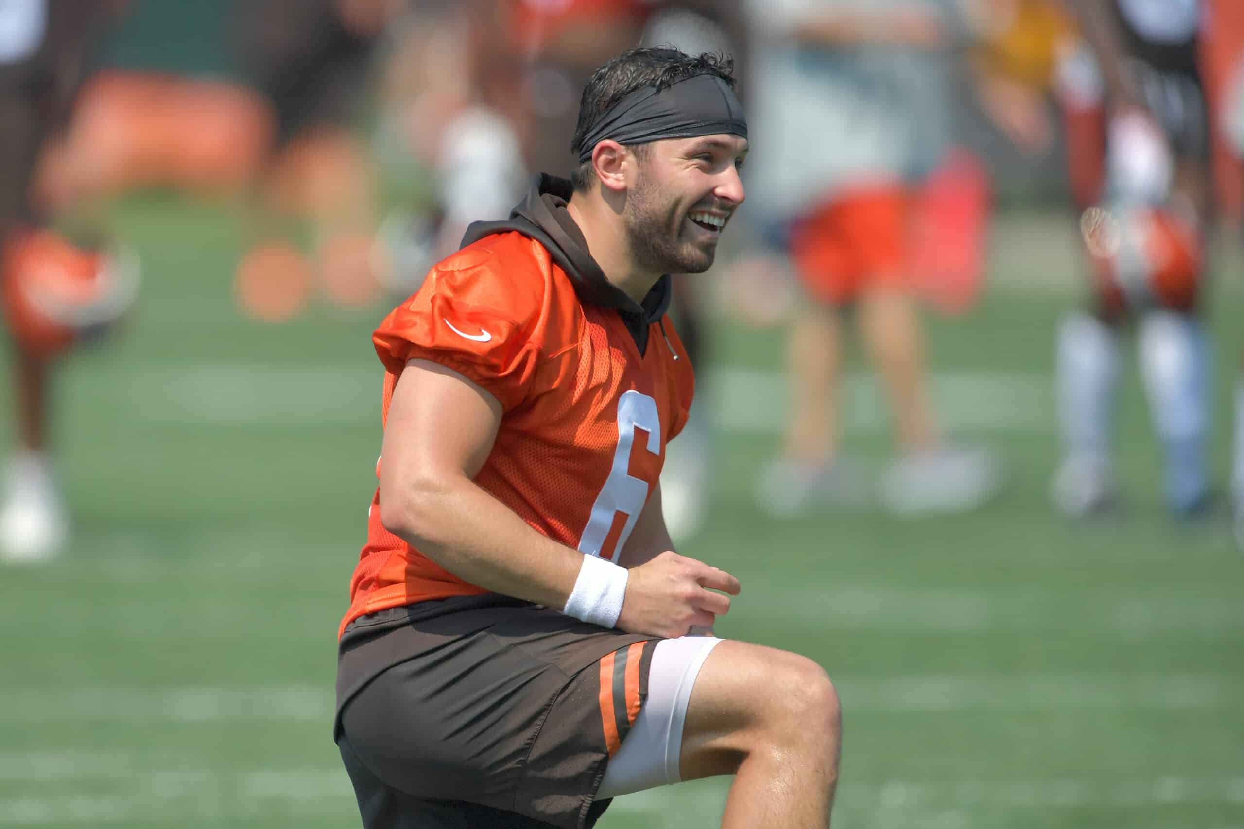 Quarterback Baker Mayfield #6 of the Cleveland Browns jokes with teammates during the first day of Cleveland Browns Training Camp on July 28, 2021 in Berea, Ohio.