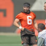 Quarterback Baker Mayfield #6 of the Cleveland Browns jokes with teammates during the first day of Cleveland Browns Training Camp on July 28, 2021 in Berea, Ohio.