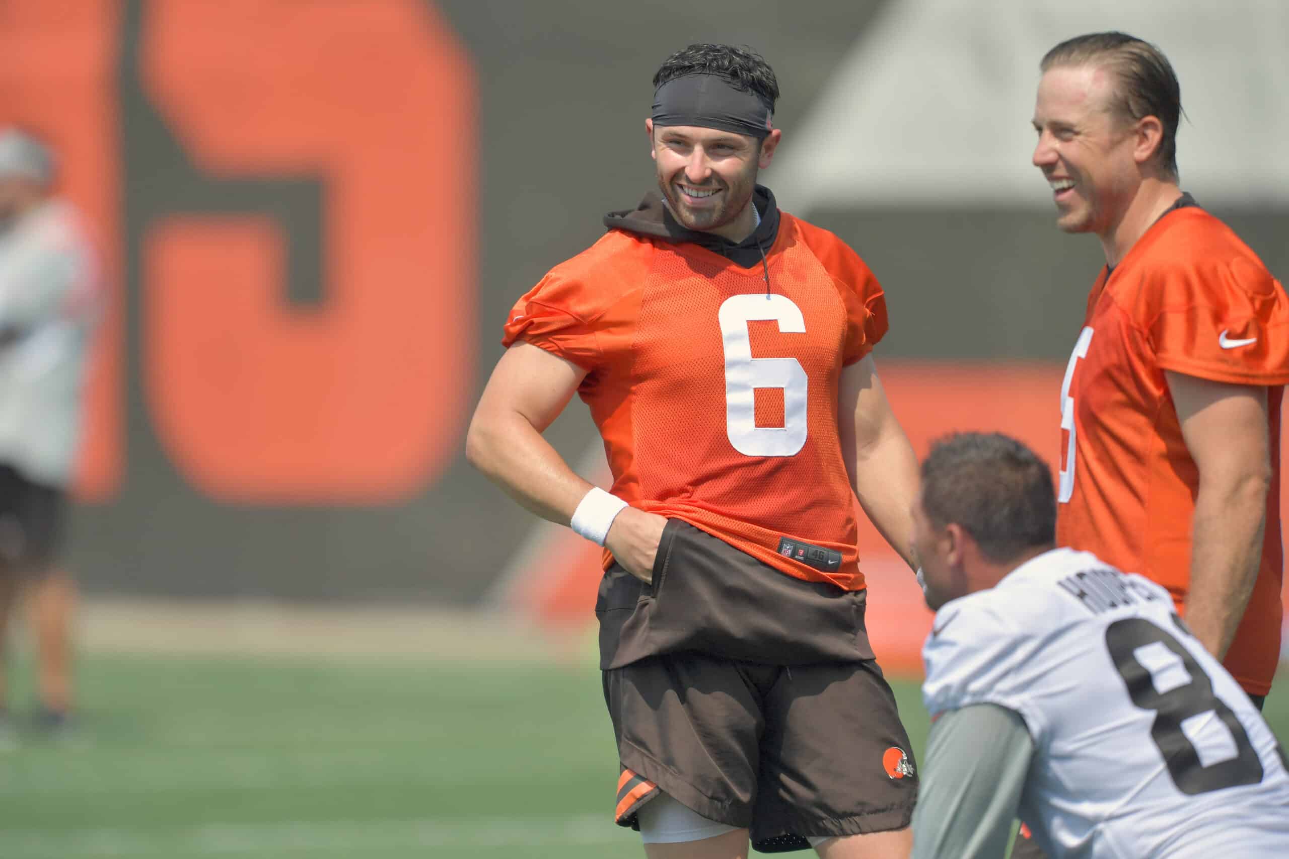 Quarterback Baker Mayfield #6 of the Cleveland Browns jokes with teammates during the first day of Cleveland Browns Training Camp on July 28, 2021 in Berea, Ohio.