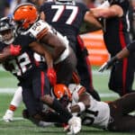 Caleb Huntley #42 of the Atlanta Falcons is tackled by Malik McDowell #58 and Mack Wilson #51 of the Cleveland Browns during the first half at Mercedes-Benz Stadium on August 29, 2021 in Atlanta, Georgia.