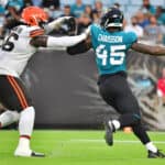 K'Lavon Chaisson #45 of the Jacksonville Jaguars rushes around James Hudson #66 of the Cleveland Browns in the first quarter during a preseason game at TIAA Bank Field on August 14, 2021 in Jacksonville, Florida.