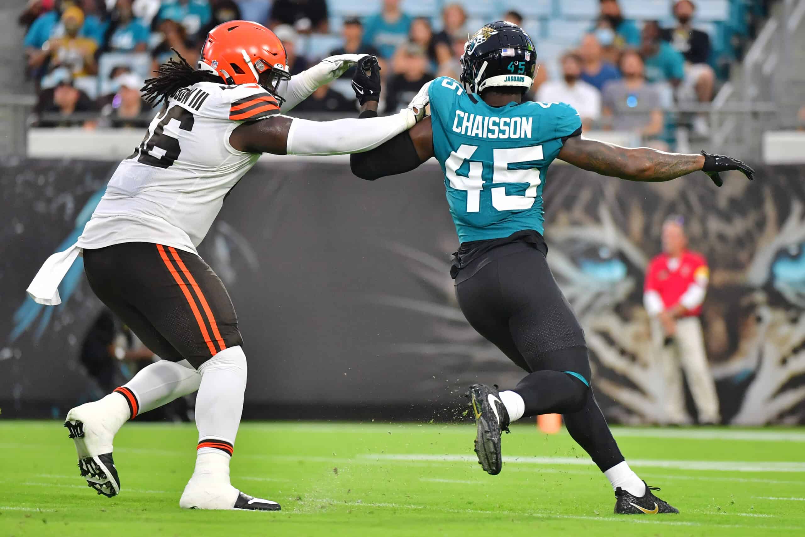 K'Lavon Chaisson #45 of the Jacksonville Jaguars rushes around James Hudson #66 of the Cleveland Browns in the first quarter during a preseason game at TIAA Bank Field on August 14, 2021 in Jacksonville, Florida.