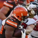 Nick Chubb #24 of the Cleveland Browns runs the ball defended by Brooks Reed #50 of the Atlanta Falcons at FirstEnergy Stadium on November 11, 2018 in Cleveland, Ohio.