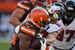 Nick Chubb #24 of the Cleveland Browns runs the ball defended by Brooks Reed #50 of the Atlanta Falcons at FirstEnergy Stadium on November 11, 2018 in Cleveland, Ohio.