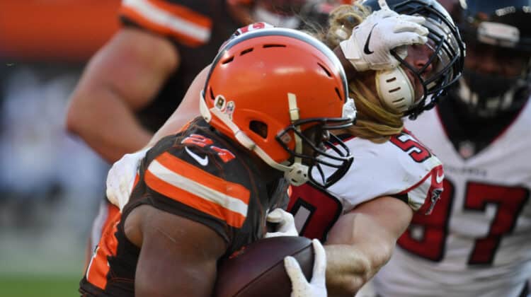 Nick Chubb #24 of the Cleveland Browns runs the ball defended by Brooks Reed #50 of the Atlanta Falcons at FirstEnergy Stadium on November 11, 2018 in Cleveland, Ohio.