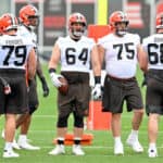 JC Tretter #64 of the Cleveland Browns helps run a drill during the second day of Cleveland Browns Training Camp on July 29, 2021 in Berea, Ohio.