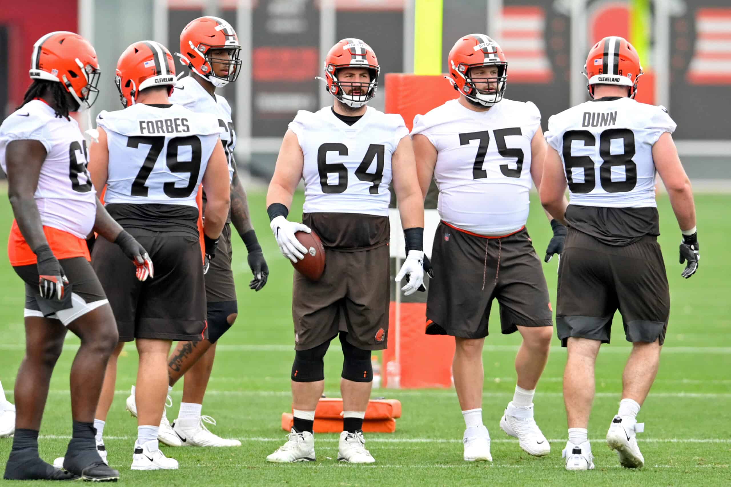 JC Tretter #64 of the Cleveland Browns helps run a drill during the second day of Cleveland Browns Training Camp on July 29, 2021 in Berea, Ohio.