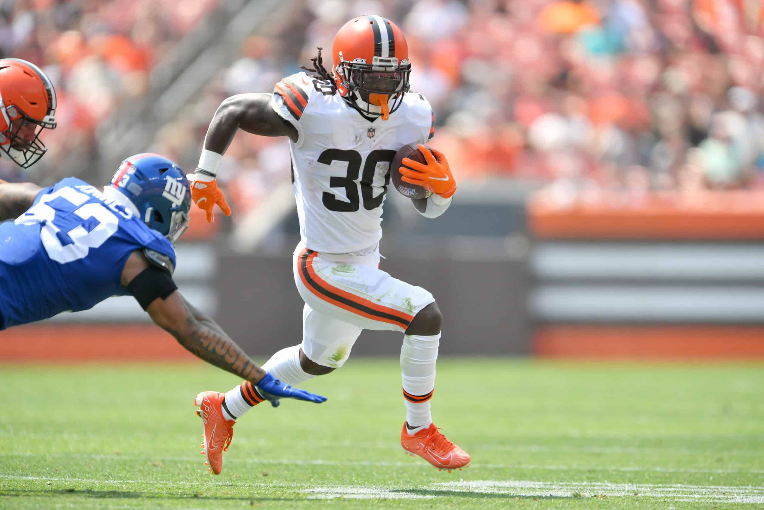 Linebacker Oshane Ximines #53 of the New York Giants misses the tackle on running back D'Ernest Johnson #30 of the Cleveland Browns during the first quarter at FirstEnergy Stadium on August 22, 2021 in Cleveland, Ohio.