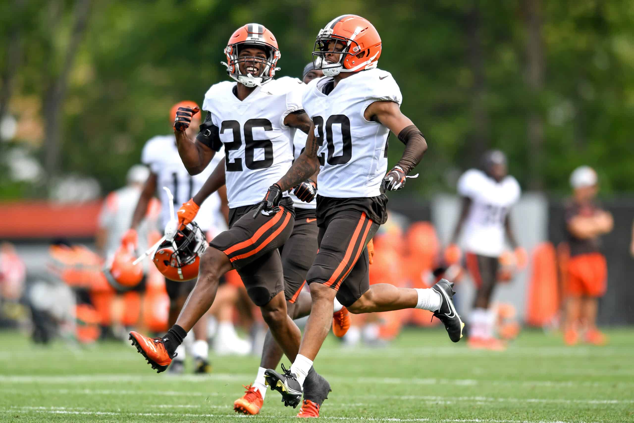 Greedy Williams #26 and Greg Newsome II #20 of the Cleveland Browns celebrate an interception by Newsome during a joint practice with the New York Giants on August 19, 2021 in Berea, Ohio.