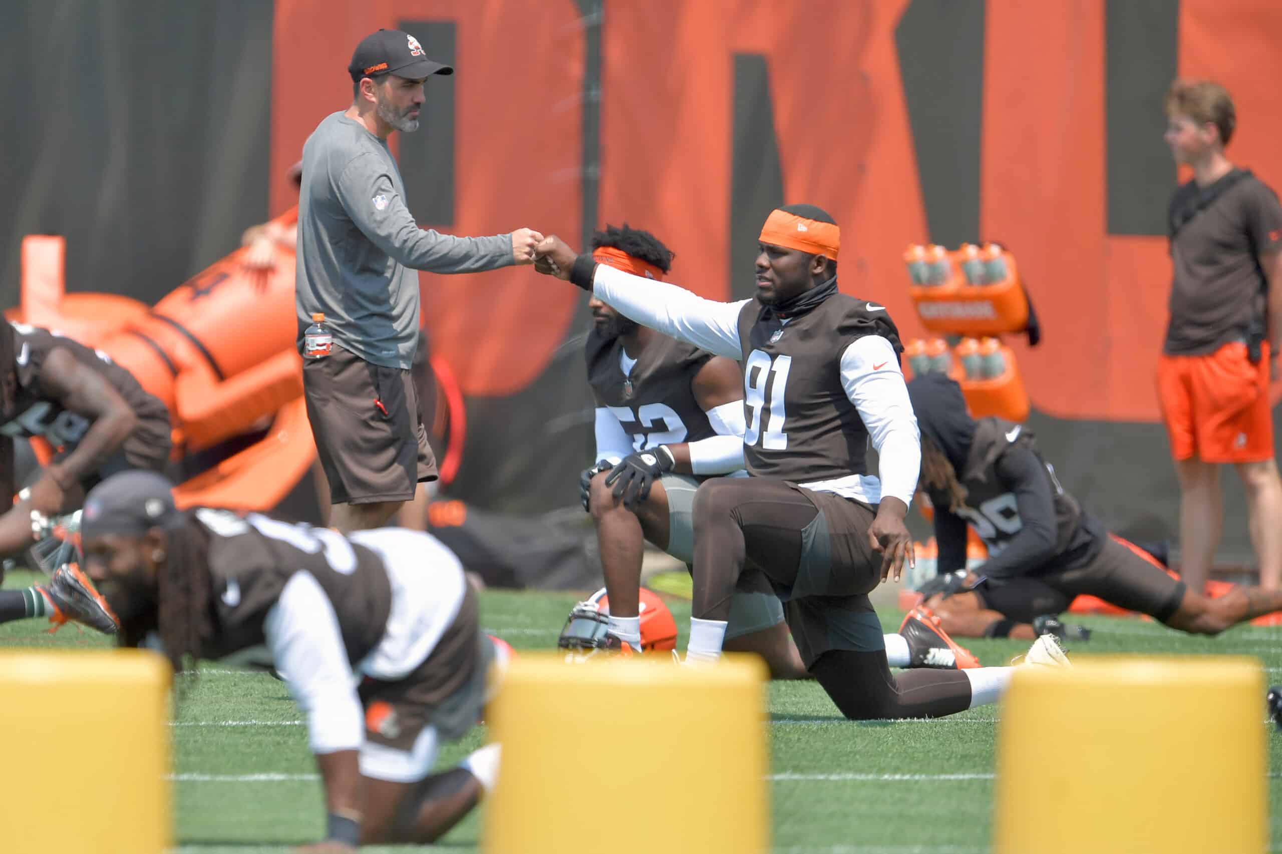 Head coach Kevin Stefanski talks with defensive end Joe Jackson #91 of the Cleveland Browns as he warms up during the first day of Cleveland Browns Training Camp on July 28, 2021 in Berea, Ohio.