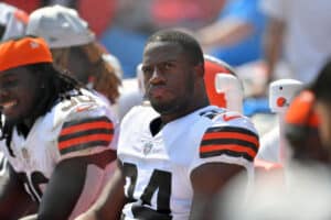 Running back Nick Chubb #24 of the Cleveland Browns watches from the bench during the fourth quarter against the New York Giants at FirstEnergy Stadium on August 22, 2021 in Cleveland, Ohio. The Browns defeated the Giants 17-13.