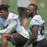 Wide receiver Rashard Higgins #82 and wide receiver Jarvis Landry #80 of the Cleveland Browns talk with teammates during the first day of Cleveland Browns Training Camp on July 28, 2021 in Berea, Ohio.