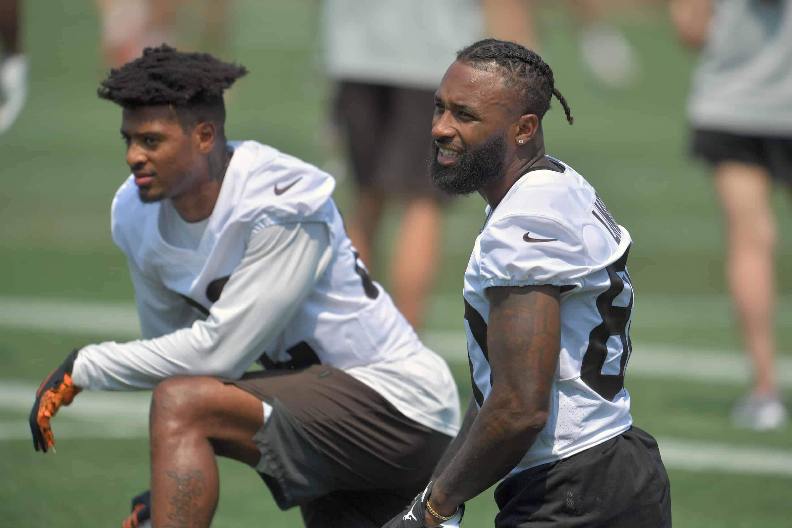 Wide receiver Rashard Higgins #82 and wide receiver Jarvis Landry #80 of the Cleveland Browns talk with teammates during the first day of Cleveland Browns Training Camp on July 28, 2021 in Berea, Ohio.