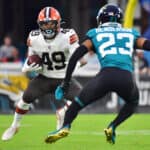 C.J. Henderson #23 of the Jacksonville Jaguars looks to tackle John Kelly #49 of the Cleveland Browns in the second quarter during a preseason game at TIAA Bank Field on August 14, 2021 in Jacksonville, Florida.