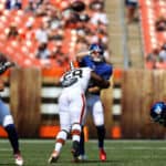 New York Giants quarterback Brian Lewerke (6) is hit by Cleveland Browns defensive tackle Malik McDowell (58) as he throws a pass during the fourth quarter of the National Football League preseason game between the New York Giants and Cleveland Browns on August 22, 2021, at FirstEnergy Stadium in Cleveland, OH.