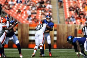 New York Giants quarterback Brian Lewerke (6) is hit by Cleveland Browns defensive tackle Malik McDowell (58) as he throws a pass during the fourth quarter of the National Football League preseason game between the New York Giants and Cleveland Browns on August 22, 2021, at FirstEnergy Stadium in Cleveland, OH.