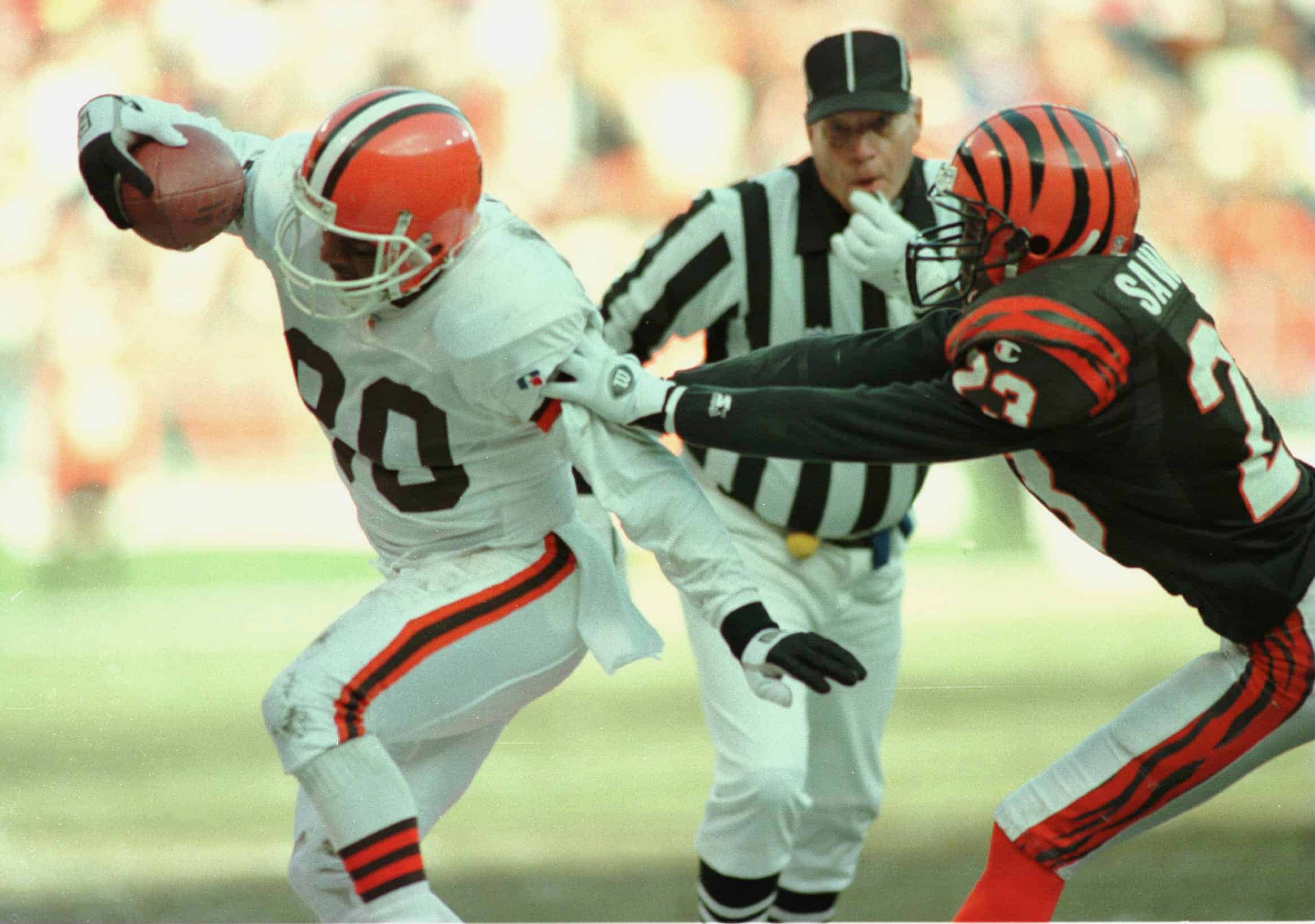 CLEVELAND BROWNS WIDE RECEIVER ANDRE RISON IS DRIVEN OUT OF BOUNDS BY CORNERBACK COREY SAWYER OF THE CINCINNATI BENGALS DURING THE FIRST HALF OF THE BROWNS'' 26-10 VICTORY AT CLEVELAND STADIUM IN CLEVELAND, OHIO.