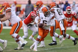 Quarterback Baker Mayfield #6 of the Cleveland Browns drops back to pass against the defense of the Kansas City Chiefs during the AFC Divisional Playoff game at Arrowhead Stadium on January 17, 2021 in Kansas City, Missouri.