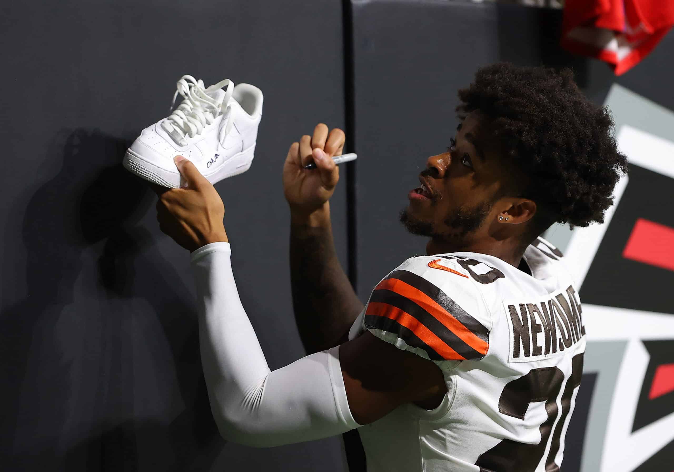 Greg Newsome II #20 of the Cleveland Browns signs autographs after their 19-10 win over the Atlanta Falcons at Mercedes-Benz Stadium on August 29, 2021 in Atlanta, Georgia.