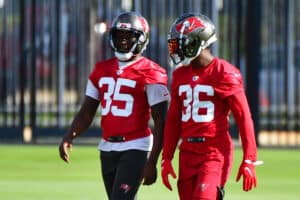 Jamel Dean #35 and Herb Miller #36 of the Tampa Bay Buccaneers converse during the Buccaneers Mini-Camp at AdventHealth Training Center on June 08, 2021 in Tampa, Florida.