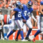 Cornerback Quincy Wilson #28 celebrates with defensive end Ifeadi Odenigbo #44 of the New York Giants after Wilson caught an interception during the second quarter against the Cleveland Browns at FirstEnergy Stadium on August 22, 2021 in Cleveland, Ohio.