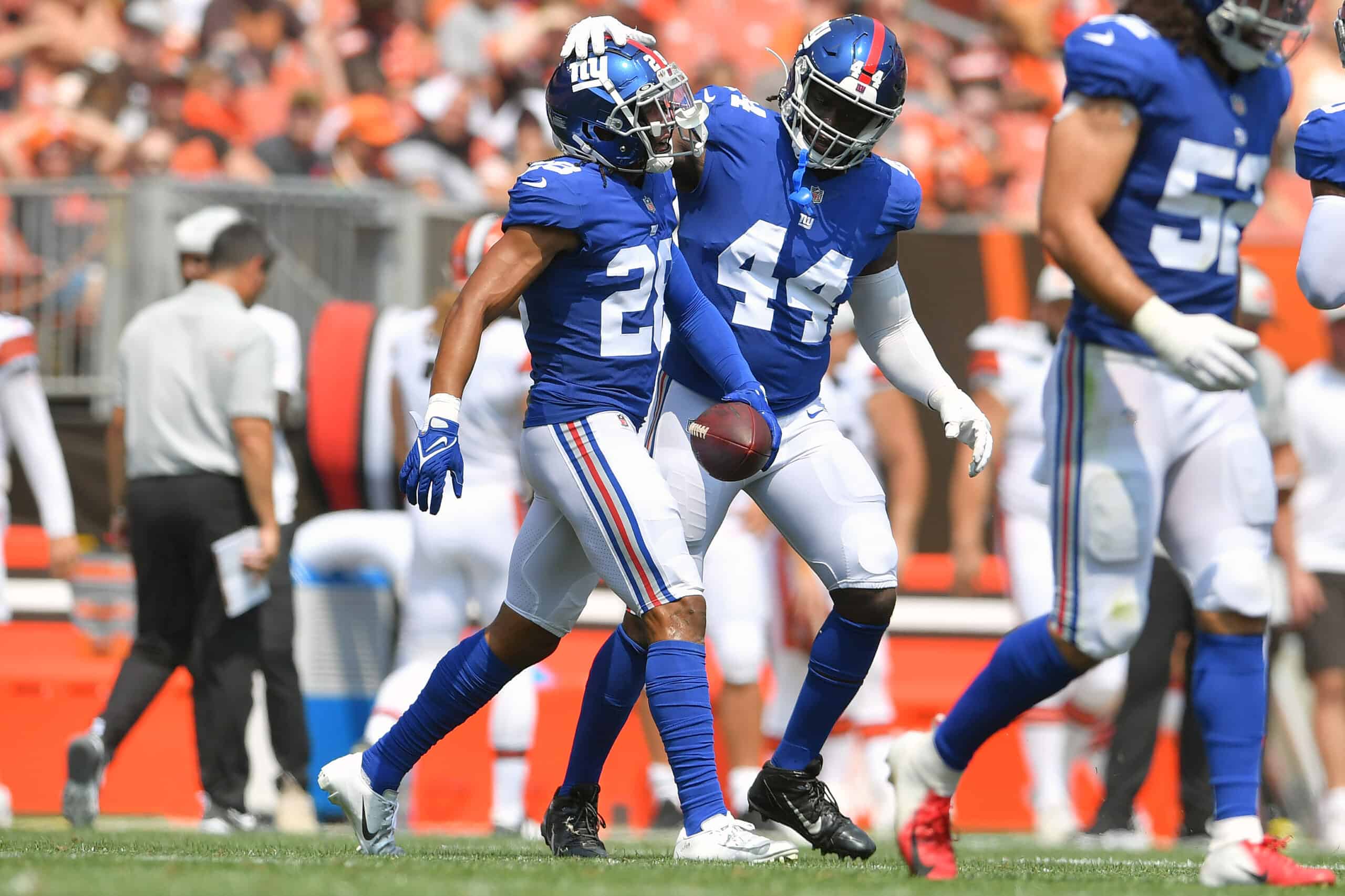 Cornerback Quincy Wilson #28 celebrates with defensive end Ifeadi Odenigbo #44 of the New York Giants after Wilson caught an interception during the second quarter against the Cleveland Browns at FirstEnergy Stadium on August 22, 2021 in Cleveland, Ohio.