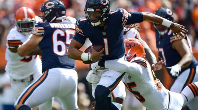 Justin Fields #1 of the Chicago Bears tries to avoid a sack by Myles Garrett #95 of the Cleveland Browns during the first half at FirstEnergy Stadium on September 26, 2021 in Cleveland, Ohio.