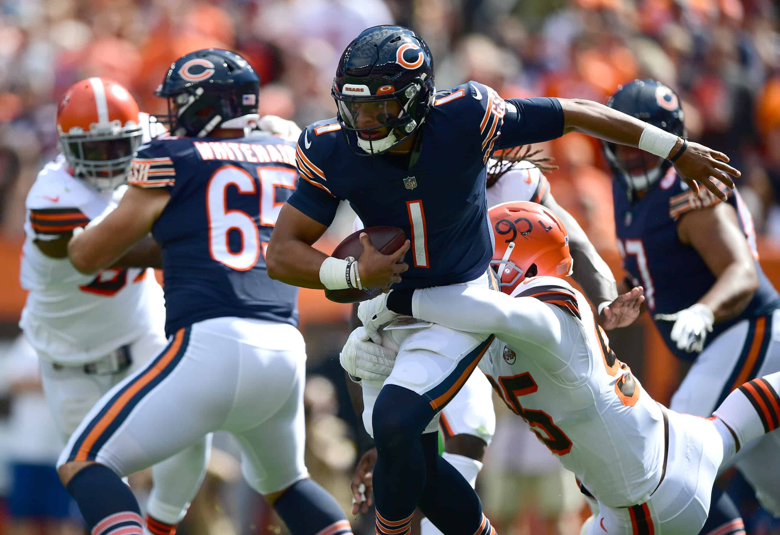 Justin Fields #1 of the Chicago Bears tries to avoid a sack by Myles Garrett #95 of the Cleveland Browns during the first half at FirstEnergy Stadium on September 26, 2021 in Cleveland, Ohio.