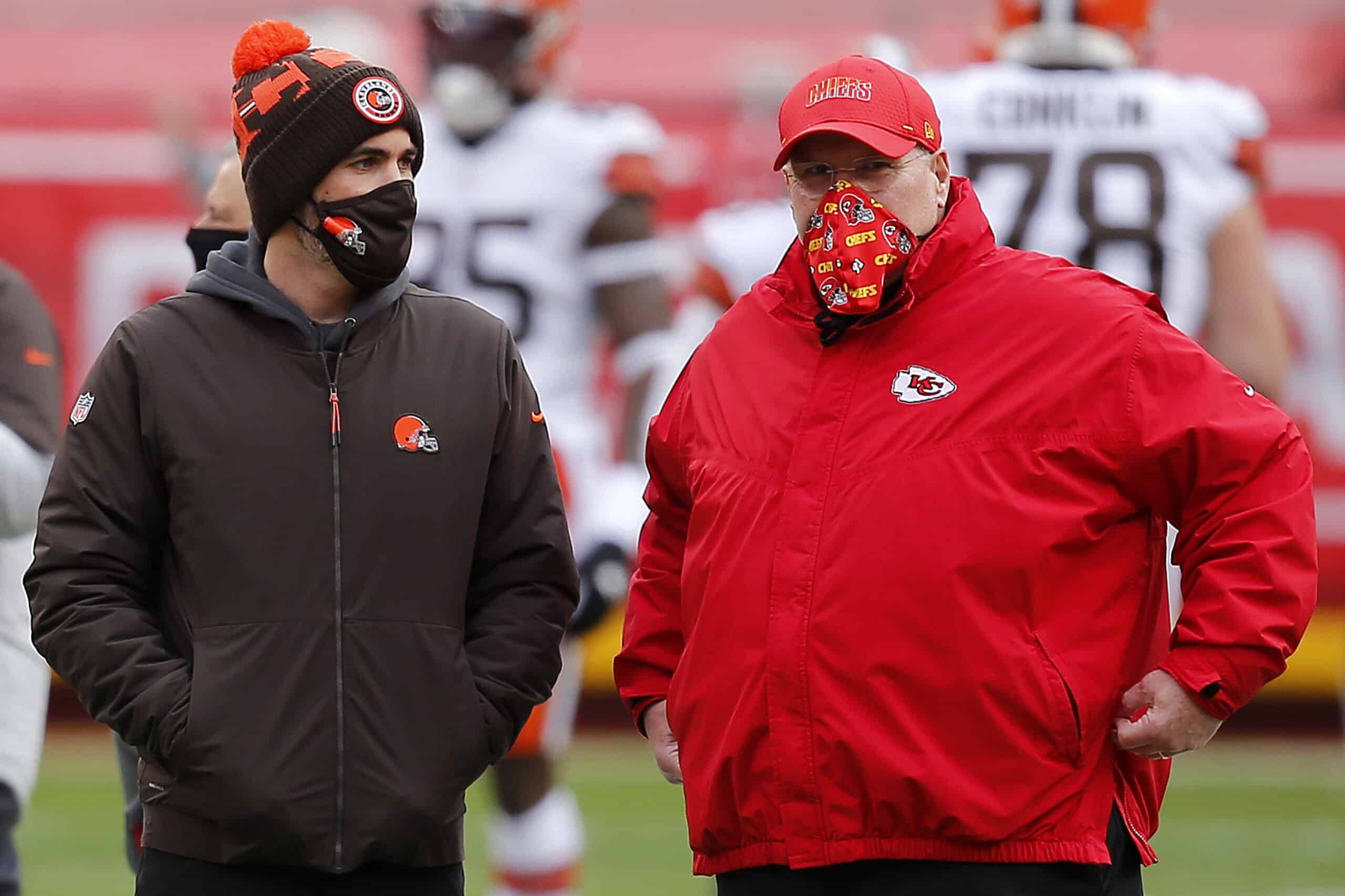 Head coach Kevin Stefanski of the Cleveland Browns and head coach Andy Reid of the Kansas City Chiefs talk on the field prior to the AFC Divisional Playoff game at Arrowhead Stadium on January 17, 2021 in Kansas City, Missouri.