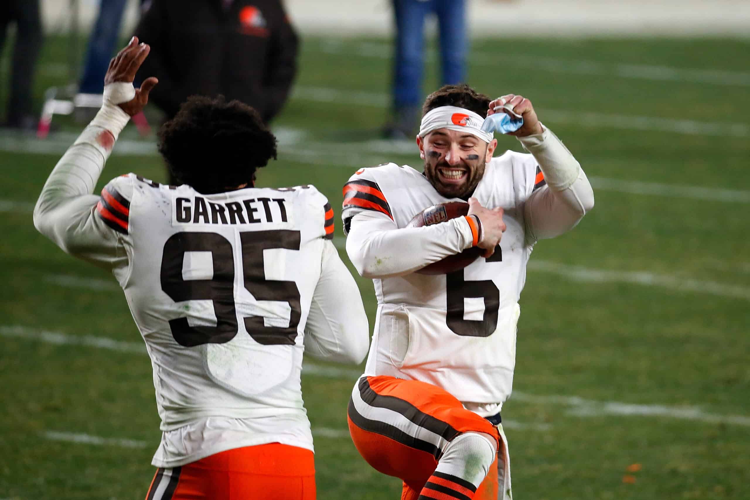 Baker Mayfield #6 and Myles Garrett #95 of the Cleveland Browns celebrate a victory over the Pittsburgh Steelers in the AFC Wild Card Playoff game at Heinz Field on January 10, 2021 in Pittsburgh, Pennsylvania.