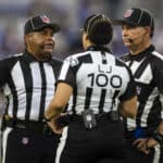 Referees meet to discuss a play during the first half of a preseason game between the Baltimore Ravens and the New Orleans Saints at M&T Bank Stadium on August 14, 2021 in Baltimore, Maryland.