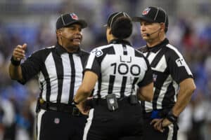 Referees meet to discuss a play during the first half of a preseason game between the Baltimore Ravens and the New Orleans Saints at M&T Bank Stadium on August 14, 2021 in Baltimore, Maryland.