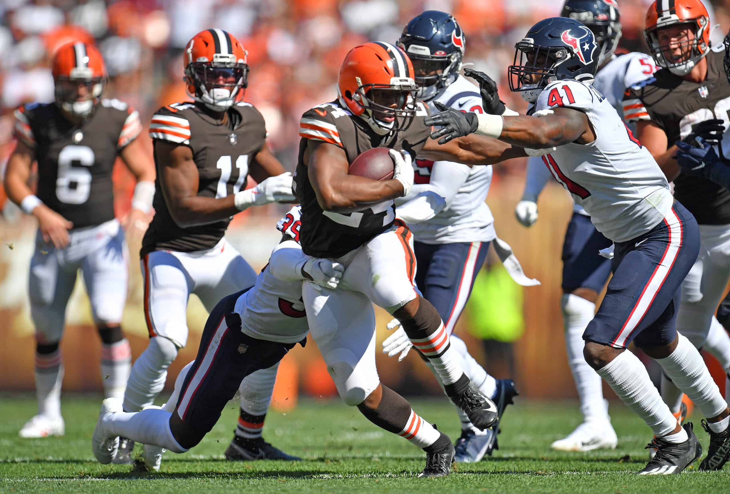 Running back Nick Chubb #24 of the Cleveland Browns tries to avoid a tackle by inside linebacker Zach Cunningham #41 of the Houston Texans during the second half at FirstEnergy Stadium on September 19, 2021 in Cleveland, Ohio.