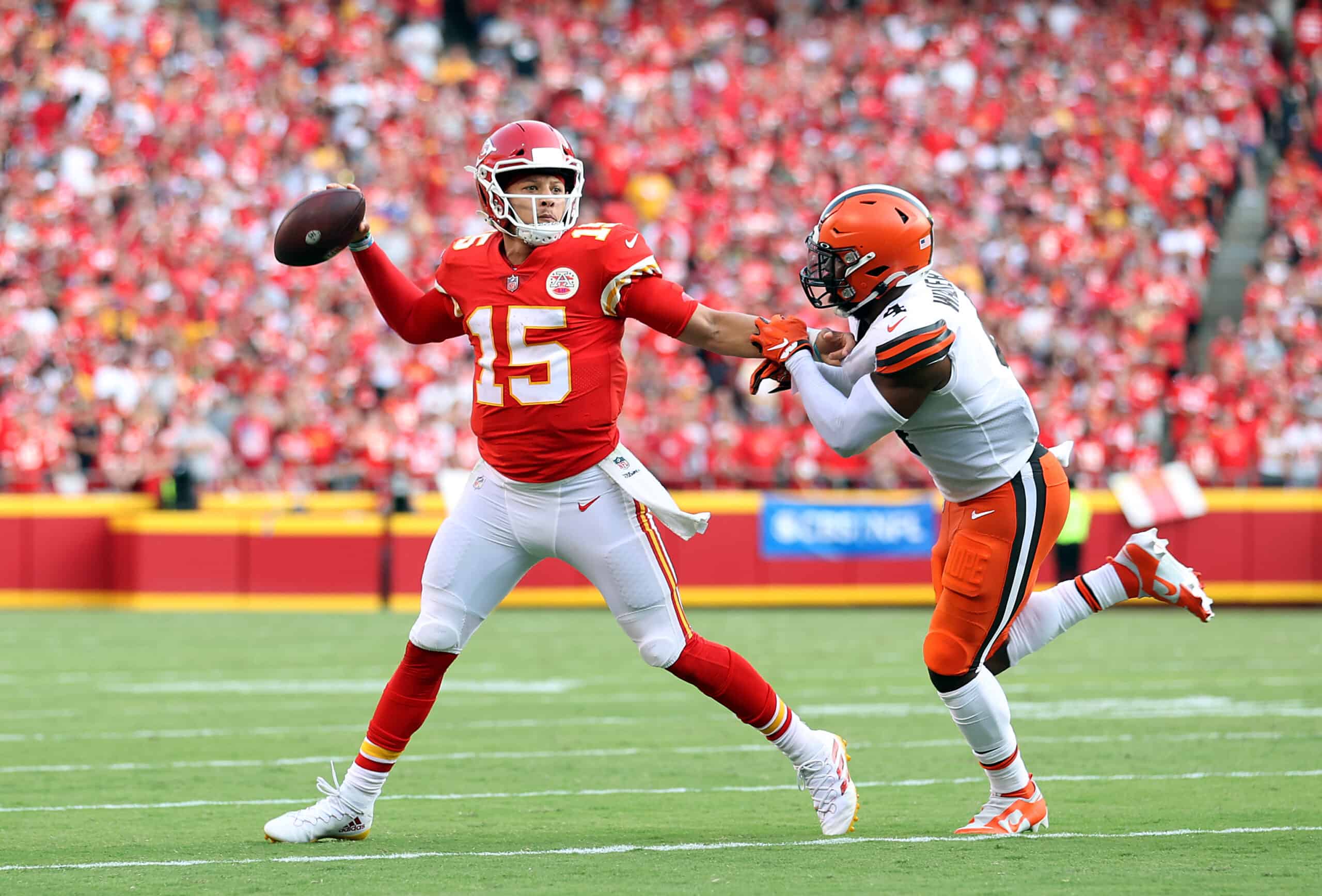 Quarterback Patrick Mahomes #15 of the Kansas City Chiefs scrambles as middle linebacker Anthony Walker #4 of the Cleveland Browns chases during the game at Arrowhead Stadium on September 12, 2021 in Kansas City, Missouri. 