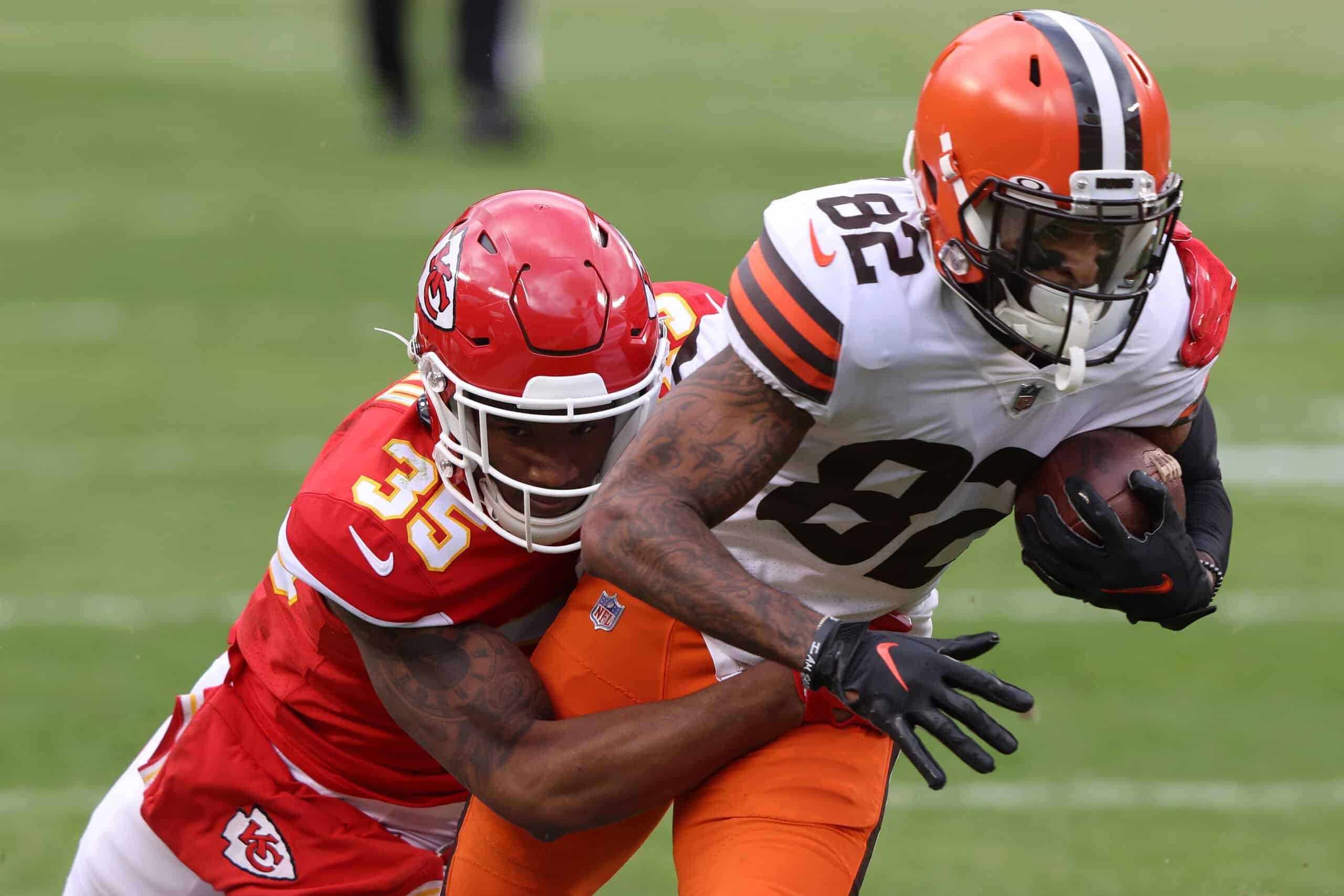 JANUARY 17: Wide receiver Rashard Higgins #82 of the Cleveland Browns is tackled after a completing a pass by cornerback Charvarius Ward #35 of the Kansas City Chiefs during the second quarter of the AFC Divisional Playoff game at Arrowhead Stadium on January 17, 2021 in Kansas City, Missouri.