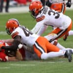Tight end Travis Kelce #87 of the Kansas City Chiefs completes a pass over strong safety Karl Joseph #42 and strong safety Ronnie Harrison #33 of the Cleveland Browns during the third quarter at Arrowhead Stadium on January 17, 2021 in Kansas City, Missouri.