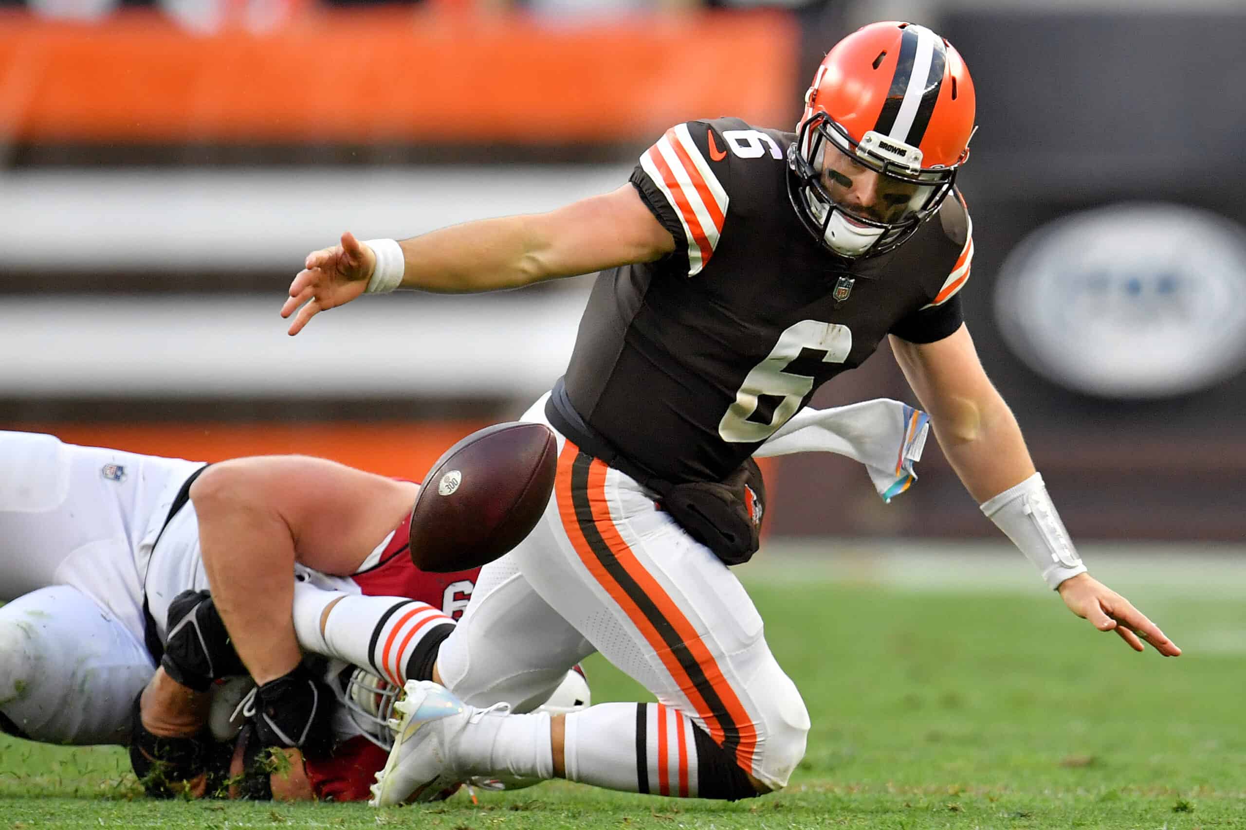 Baker Mayfield #6 of the Cleveland Browns fumbles the ball after a tackle from J.J. Watt #99 of the Arizona Cardinals during the third quarter at FirstEnergy Stadium on October 17, 2021 in Cleveland, Ohio.