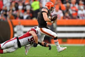 J.J. Watt #99 of the Arizona Cardinals tackles Baker Mayfield #6 of the Cleveland Browns during the third quarter at FirstEnergy Stadium on October 17, 2021 in Cleveland, Ohio.