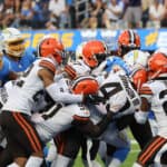 The Cleveland Browns defense pushes Austin Ekeler #30 of the Los Angeles Chargers into the endzone for a Chargers touchdown during the fourth quarter at SoFi Stadium on October 10, 2021 in Inglewood, California.